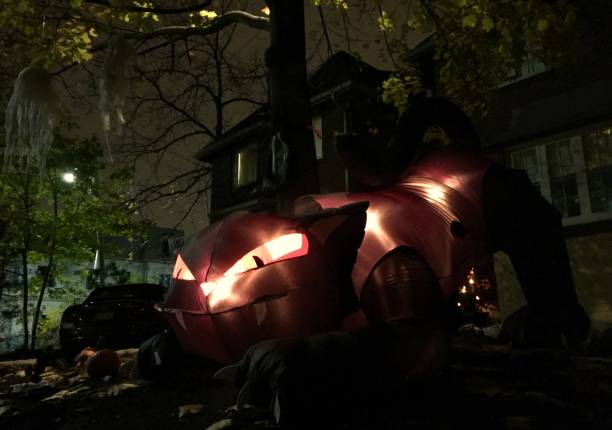 halloween decoration featuring a giant cat with glowing eyes on a front yard somewhere in a toronto suburb - garden decoration stock pictures, royalty-free photos & images