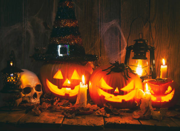 halloween jack-o-lantern pumpkins on rustic wooden background - home decoration stock pictures, royalty-free photos & images