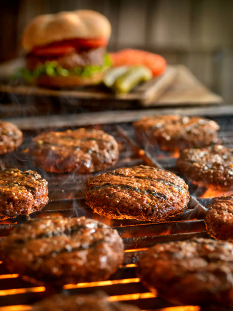 hamburgers on the bbq - food stock pictures, royalty-free photos & images