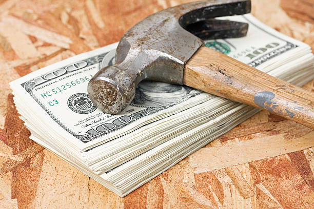 hammer on stack of money - home decoration stock pictures, royalty-free photos & images