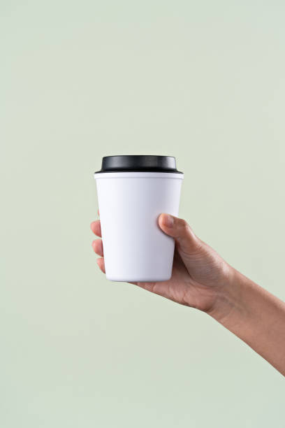 hand holding a reusable coffee cup - junk food stock pictures, royalty-free photos & images