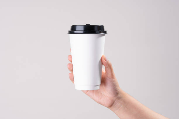 hand holding white paper cup - junk food stock pictures, royalty-free photos & images