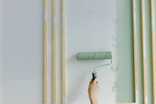 hand of woman painting with paint roller on wall at home - home decoration stock pictures, royalty-free photos & images