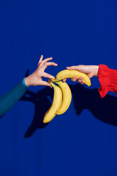 hand picking banana - food stock pictures, royalty-free photos & images