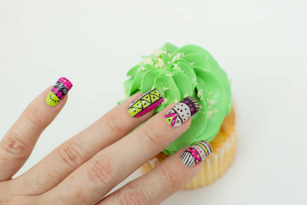 hand showing design nail art and a cupcake - nails art stock pictures, royalty-free photos & images