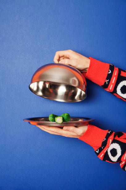 hands holding silver tray and lid during christmas - food stock pictures, royalty-free photos & images