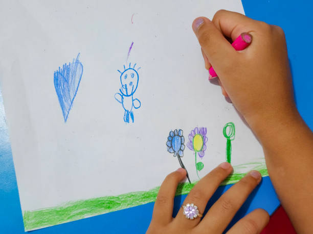 hands of a preschool child drawing and coloring on sheet of paper - nails art stock pictures, royalty-free photos & images
