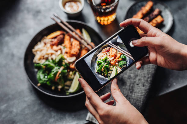 hands of cook photographing asian vegan dish - food stock pictures, royalty-free photos & images