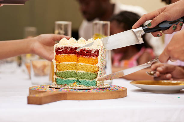 hands of guests with knife taking cake slice - garden decoration stockfoto's en -beelden