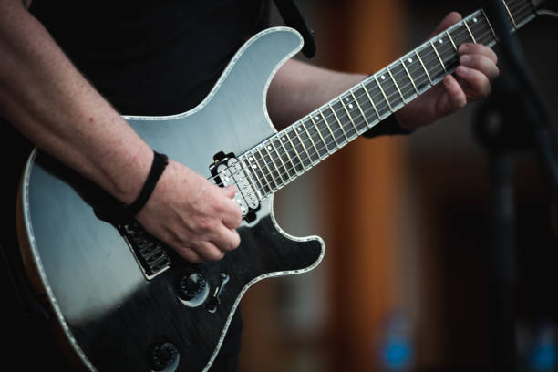 hands playing a chord on an electric guitar - concert stock pictures, royalty-free photos & images