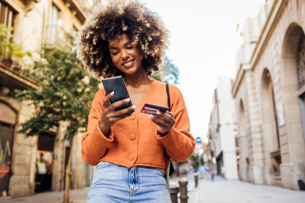happy afro girl in barcelona shopping online on the move - travel stock pictures, royalty-free photos & images