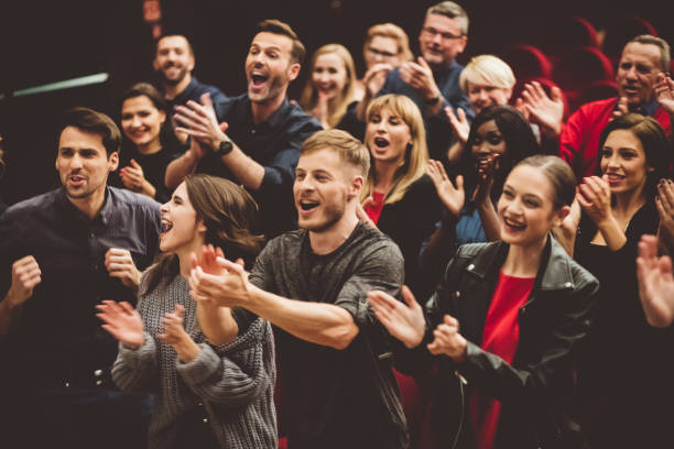 happy audience applauding in the theater - concert stock pictures, royalty-free photos & images
