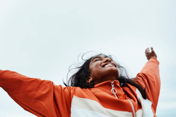 happy black woman, freedom and sky for success in adventure, travel or achievement in the outdoors. female winner celebrating goal being free in nature for successful traveling to india in happiness - travel stock pictures, r