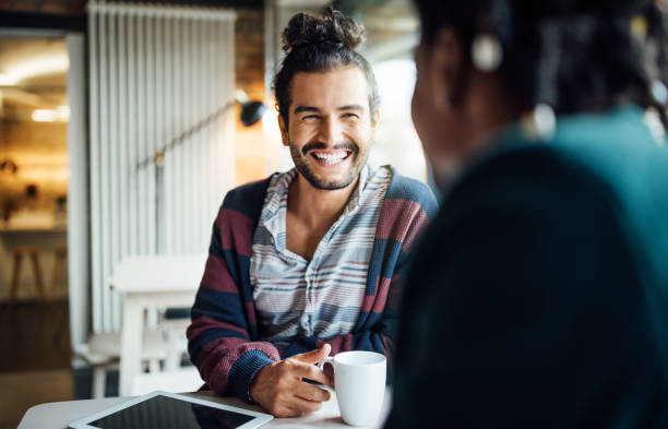 happy businessman having coffee with colleague - coffee stock pictures, royalty-free photos & images