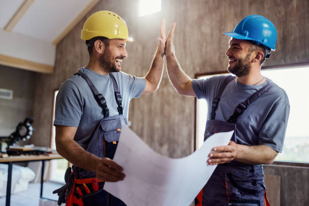 happy construction workers congratulating each other at renovating house. - home decoration stock pictures, royalty-free photos & images