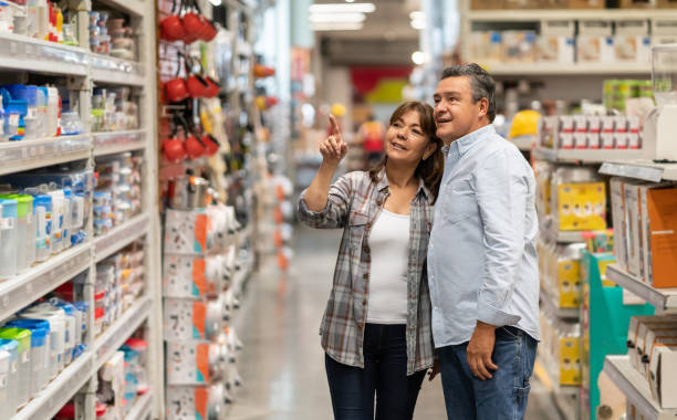 happy couple buying home supplies at a store - home decoration stock pictures, royalty-free photos & images