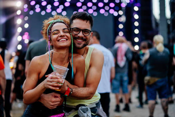 happy couple posing at concert - concert stock pictures, royalty-free photos & images