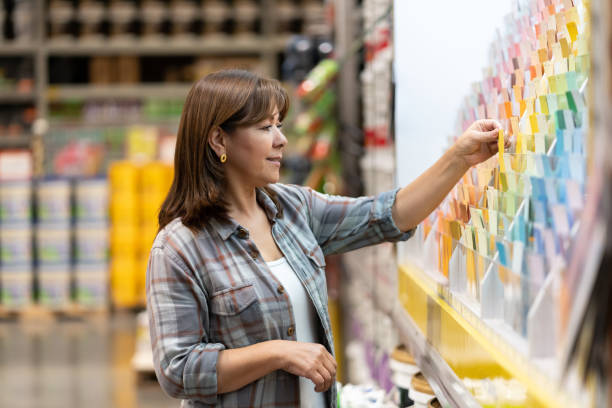 happy customer at home improvement store looking at color samples - home decoration stock pictures, royalty-free photos & images
