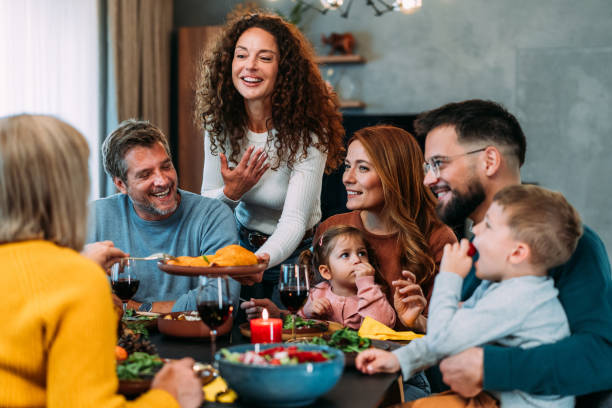 happy extended family celebrating thanksgiving at dining table. - food stock pictures, royalty-free photos & images