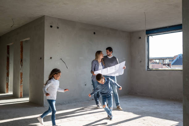 happy family analyzing plans at their new apartment - home decoration stock pictures, royalty-free photos & images