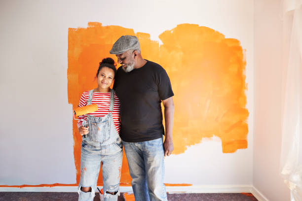 happy family renovating home - home decoration stock pictures, royalty-free photos & images