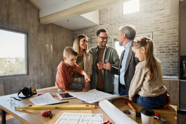 happy family talking to their architect during home renovation process. - home decoration stockfoto's en -beelden
