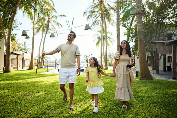 happy family walking in resort garden - travel stock pictures, royalty-free photos & images