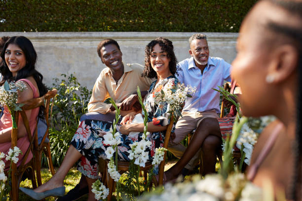 happy female and male guests looking at woman - garden decoration stock pictures, royalty-free photos & images