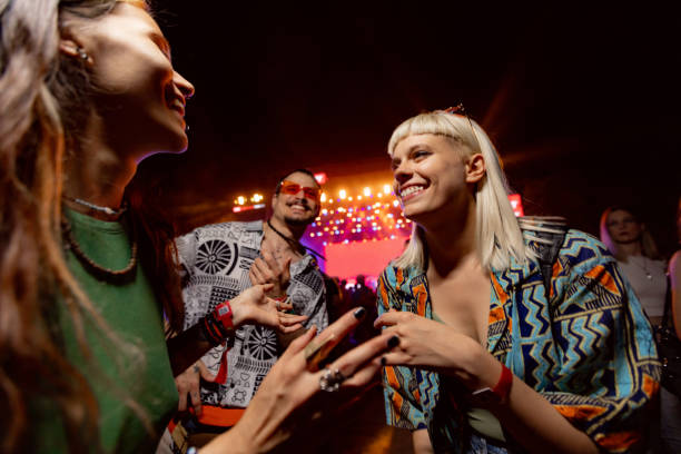 happy friends dancing on music concert by night. - concert stock pictures, royalty-free photos & images