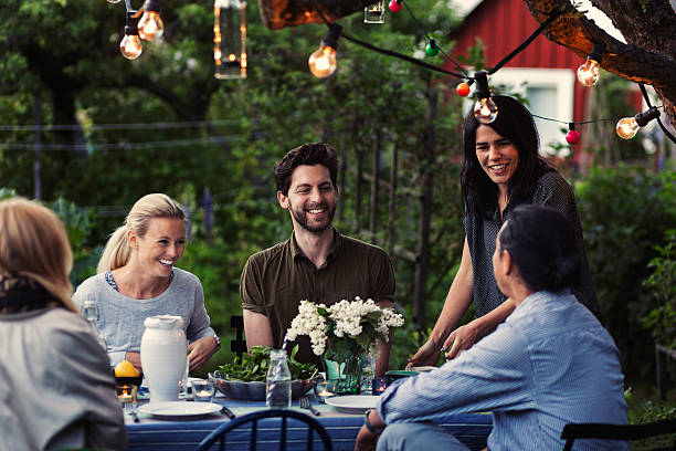 happy friends enjoying dinner party at yard - garden decoration stock pictures, royalty-free photos & images