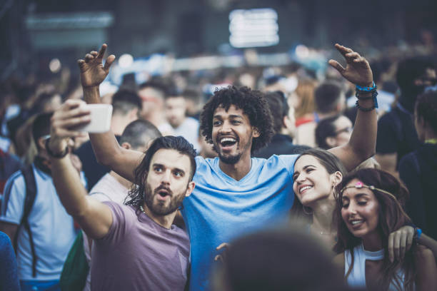 happy friends having fun while taking a selfie on a music festival. - concert stock pictures, royalty-free photos & images