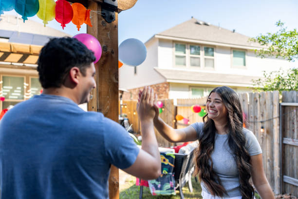 happy friends high fiving and having fun at a party - garden decoration stock pictures, royalty-free photos & images