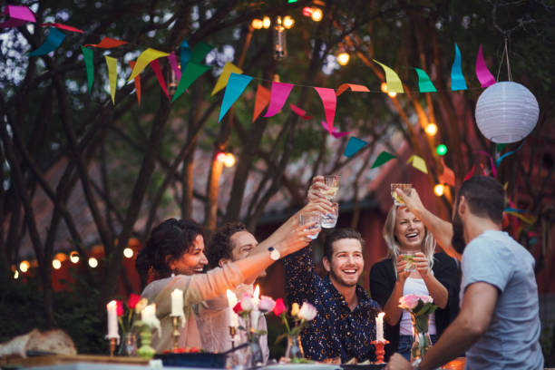 happy friends toasting drinks while enjoying at garden party - garden decoration stock pictures, royalty-free photos & images