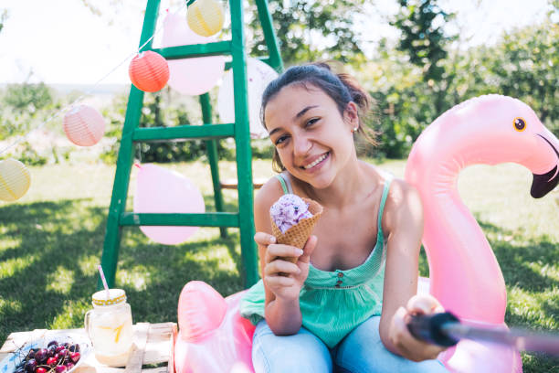 happy girl with ice cream and flamingo float - garden decoration stock pictures, royalty-free photos & images
