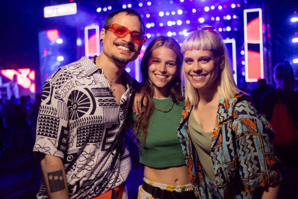 happy hipster friends enjoying on a music festival by night. - concert stock pictures, royalty-free photos & images
