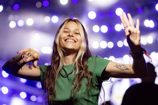 happy hipster woman dancing on a night music concert. - concert stock pictures, royalty-free photos & images