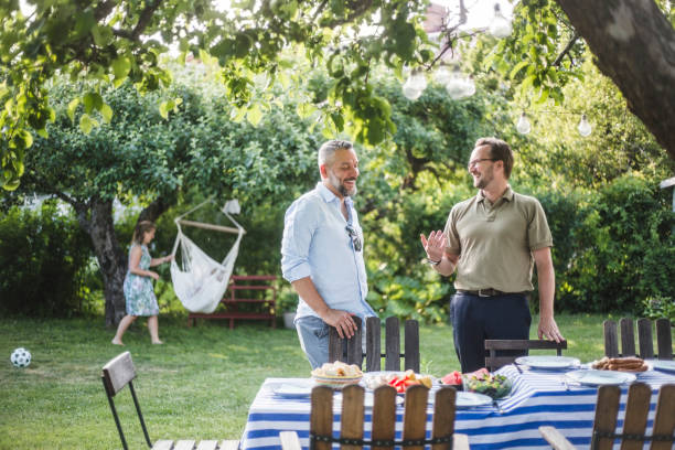 happy male friends spending weekend together during party in backyard - garden decoration photos et images de collection
