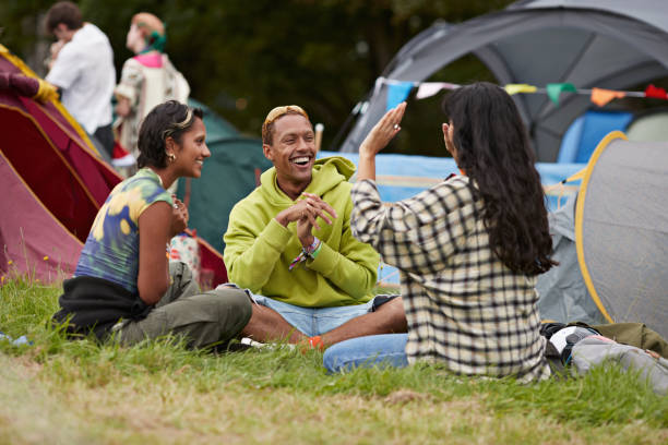 happy man and woman looking at friend gesturing - concert stock pictures, royalty-free photos & images