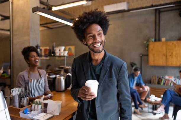 happy man at a cafe buying coffee to go - junk food stock pictures, royalty-free photos & images