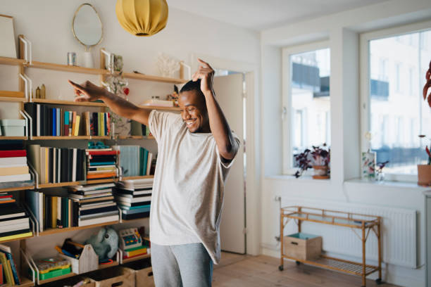 happy man dancing in living room at home - home decoration stock pictures, royalty-free photos & images