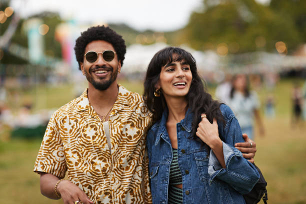 happy man walking with girlfriend at park - concert stock pictures, royalty-free photos & images
