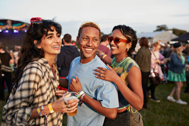 happy man with friends enjoying music festival - concert stock pictures, royalty-free photos & images