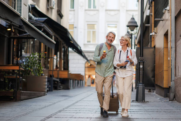 happy mature couple exploring a charming european city together - travel stock pictures, royalty-free photos & images