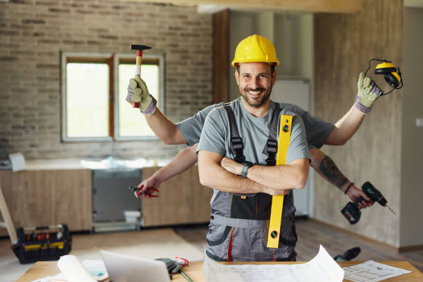 happy multi-tasking construction worker with crossed arms during renovation process. - home decoration stock pictures, royalty-free photos & images