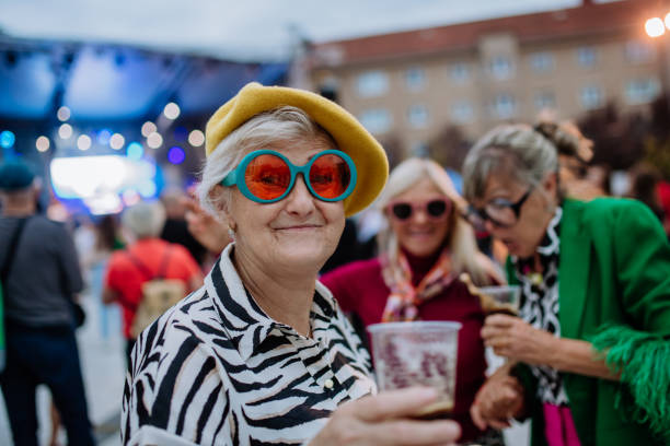 happy three senior friends having fun at outdoor concert. - concert stock pictures, royalty-free photos & images