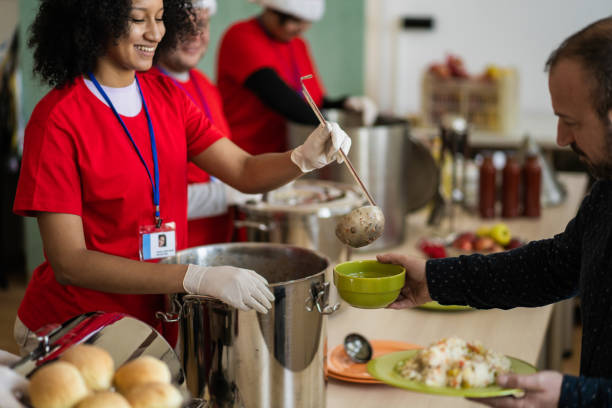 happy volunteers serving food at christmas - food stock pictures, royalty-free photos & images