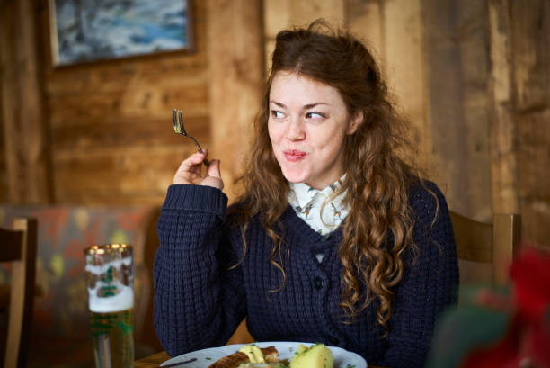happy woman eating out in a restaurant - food stock pictures, royalty-free photos & images