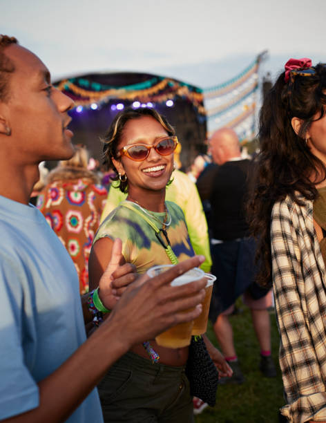 happy woman enjoying music festival with friends - concert stock pictures, royalty-free photos & images