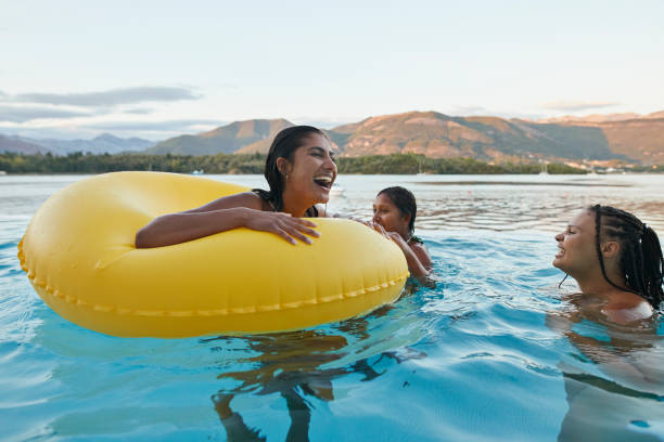 happy woman enjoying with friends in swimming pool - travel stock pictures, royalty-free photos & images