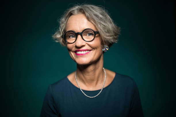 happy woman in eyeglasses against green background - fashion stock pictures, royalty-free photos & images